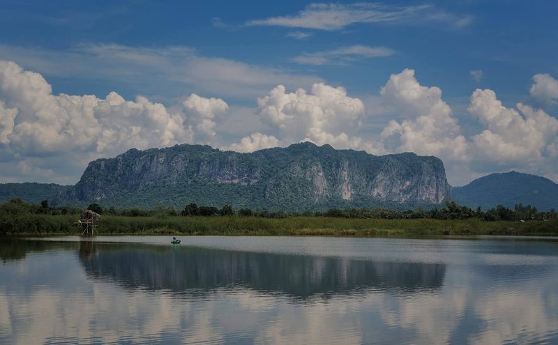 Limestone mountain in Phu Pha Man reflected in the water, a local fishing